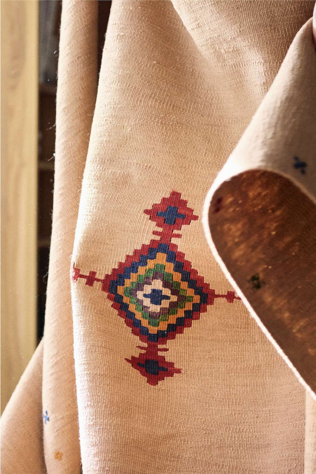 Close-up of a beige anadoloom kilim with a colorful geometric pattern